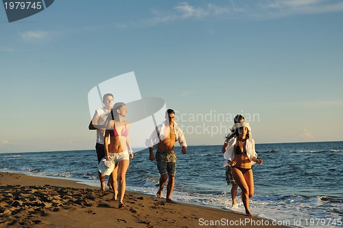 Image of people group running on the beach