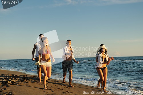Image of people group running on the beach