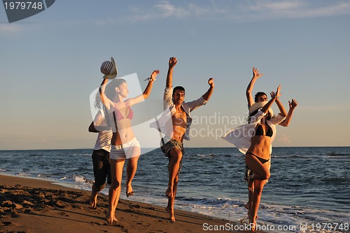 Image of people group running on the beach