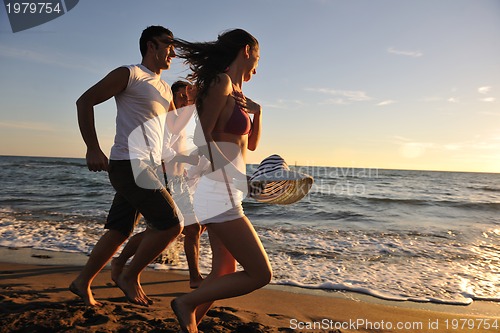 Image of people group running on the beach