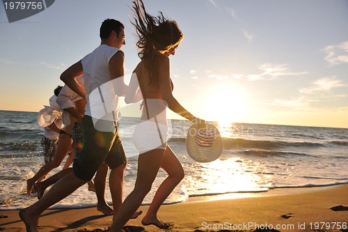 Image of people group running on the beach