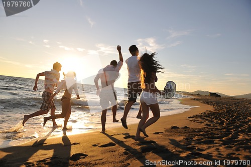 Image of people group running on the beach