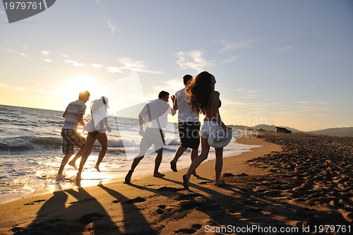 Image of people group running on the beach