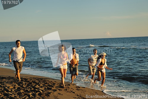 Image of people group running on the beach