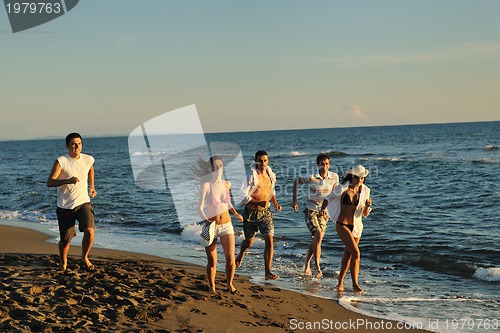 Image of people group running on the beach