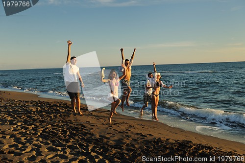 Image of people group running on the beach