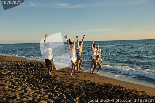 Image of people group running on the beach