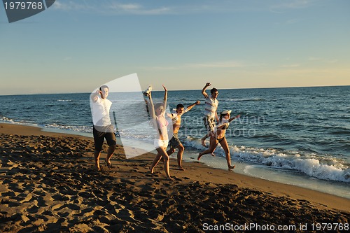 Image of people group running on the beach