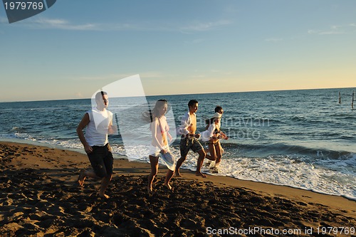 Image of people group running on the beach
