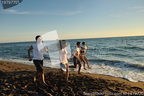 Image of people group running on the beach