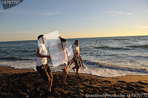 Image of people group running on the beach