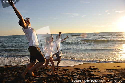 Image of people group running on the beach