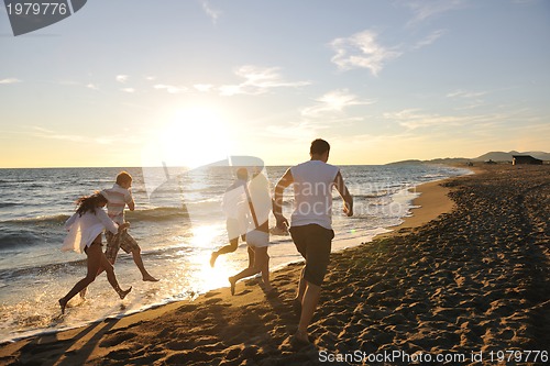 Image of people group running on the beach
