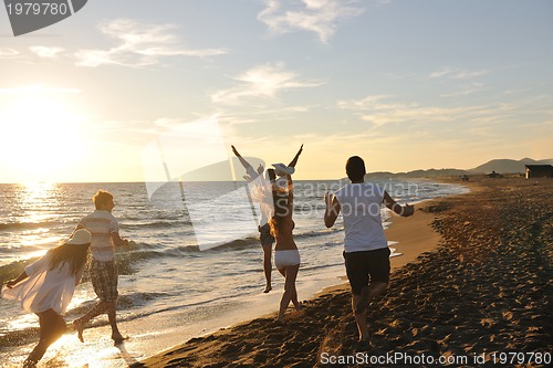 Image of people group running on the beach