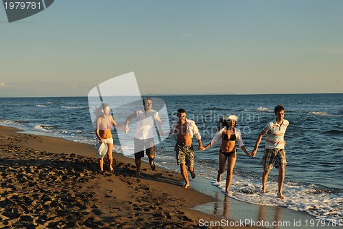 Image of people group running on the beach