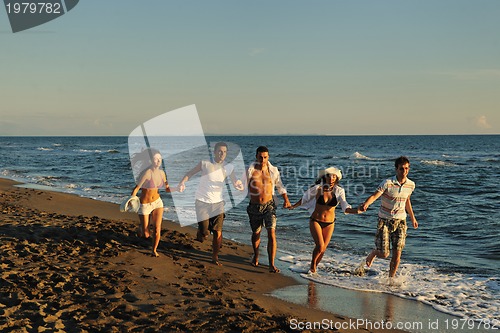 Image of people group running on the beach