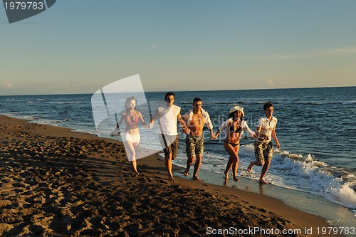Image of people group running on the beach