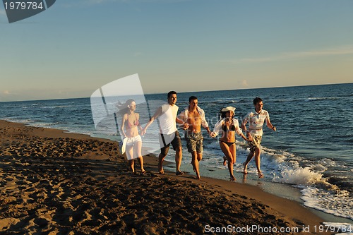 Image of people group running on the beach