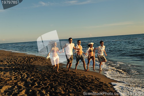 Image of people group running on the beach