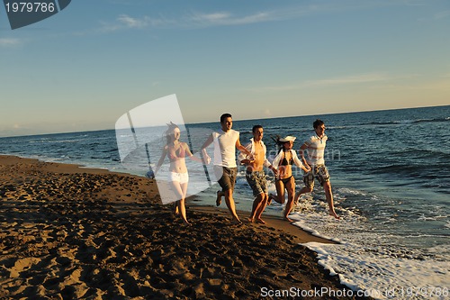 Image of people group running on the beach