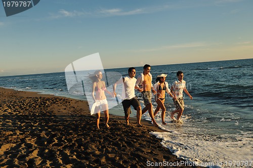 Image of people group running on the beach