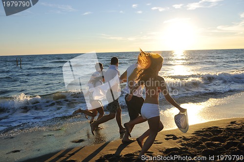 Image of people group running on the beach
