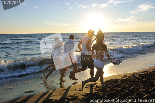 Image of people group running on the beach