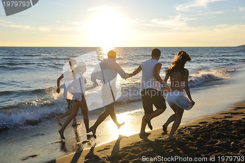 Image of people group running on the beach