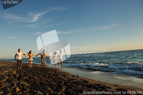 Image of people group running on the beach