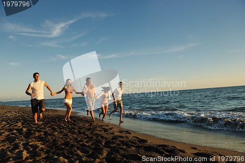 Image of people group running on the beach
