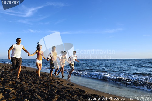 Image of people group running on the beach