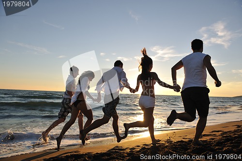 Image of people group running on the beach