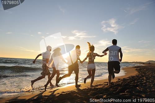 Image of people group running on the beach