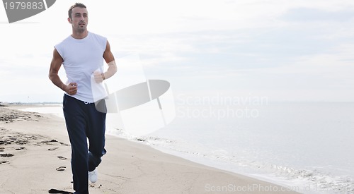 Image of man running on beach