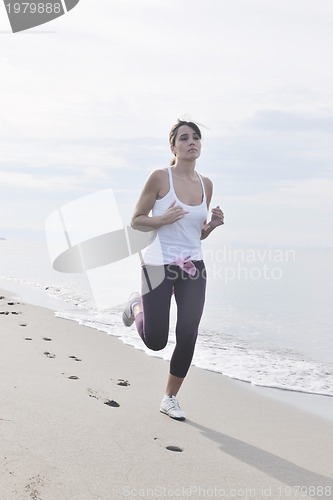 Image of woman running on beach