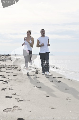 Image of couple jogging on the beach