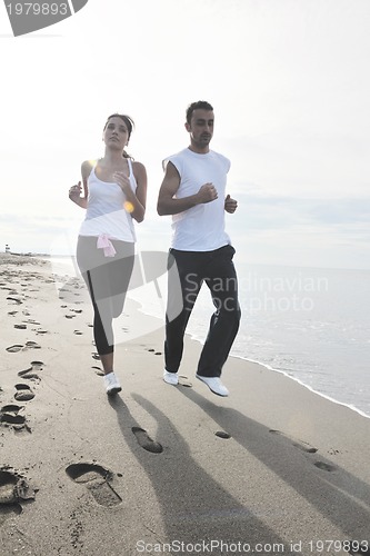 Image of couple jogging on the beach