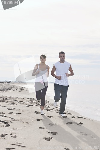 Image of couple jogging on the beach