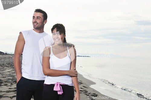 Image of happy young couple have fun at beautiful beach