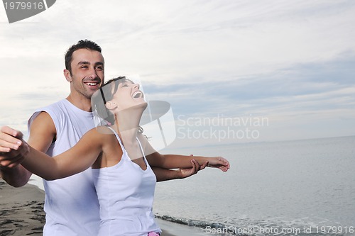 Image of happy young couple have fun at beautiful beach