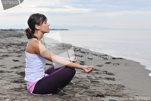 Image of woman yoga beach