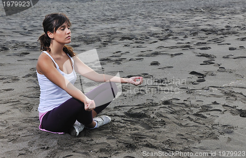 Image of woman yoga beach