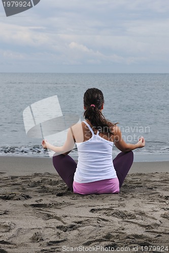 Image of woman yoga beach