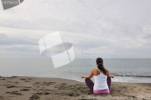 Image of woman yoga beach