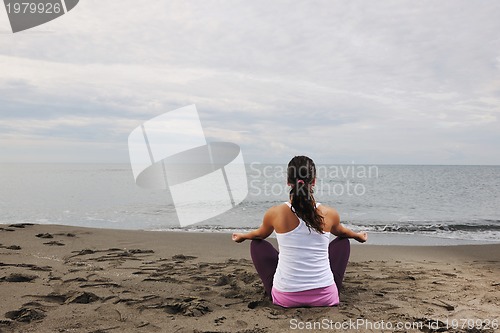 Image of woman yoga beach