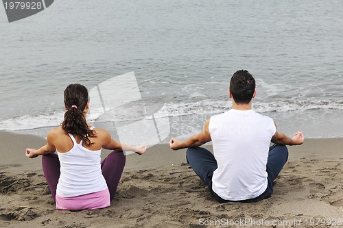 Image of couple yoga beach