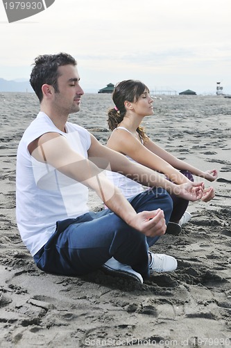 Image of couple yoga beach