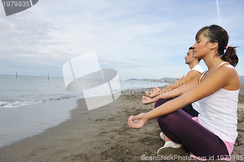 Image of couple yoga beach