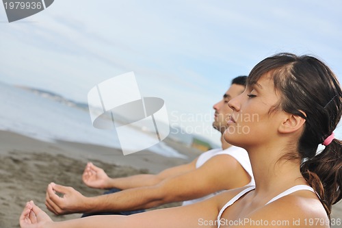 Image of couple yoga beach