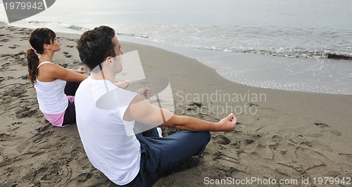 Image of couple yoga beach